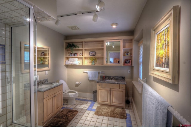 575 County Rd 253, Durango, CO 81301 - full bathroom with vanity, tile patterned flooring, toilet, a shower stall, and baseboards