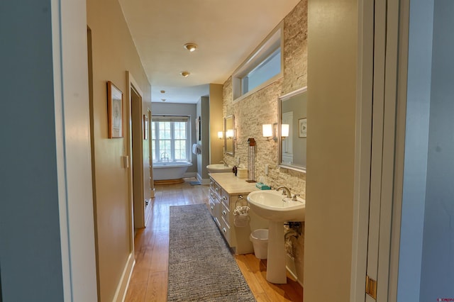 575 County Rd 253, Durango, CO 81301 - full bathroom featuring a sink, wood finished floors, and a soaking tub