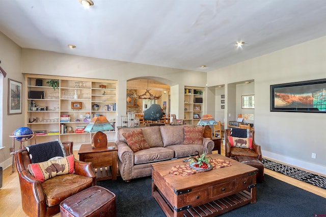 575 County Rd 253, Durango, CO 81301 - living area with arched walkways, baseboards, built in shelves, and wood finished floors