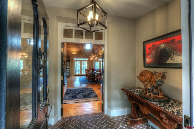 575 County Rd 253, Durango, CO 81301 - entrance foyer with a chandelier, baseboards, and brick patterned flooring