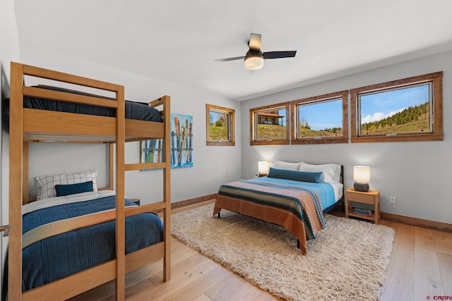 64 Buckhorn Way, Crested Butte, CO 81224 - bedroom with baseboards, light wood-style floors, and a ceiling fan