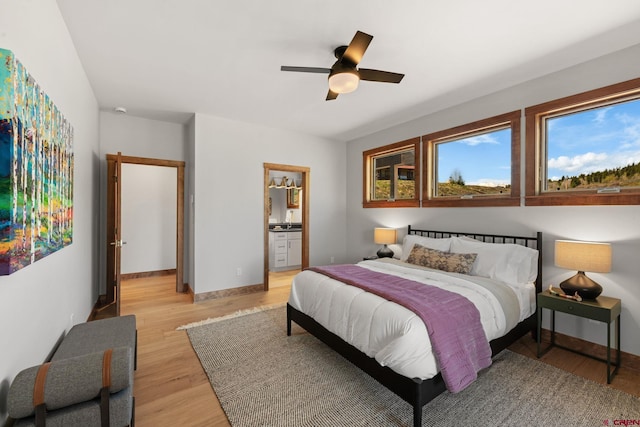 64 Buckhorn Way, Crested Butte, CO 81224 - bedroom featuring light wood-style floors, baseboards, ceiling fan, and ensuite bathroom