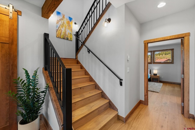 64 Buckhorn Way, Crested Butte, CO 81224 - staircase featuring wood-type flooring, baseboards, a barn door, and recessed lighting