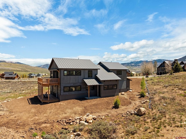64 Buckhorn Way, Crested Butte, CO 81224 - rear view of property with a standing seam roof, metal roof, and a deck with mountain view