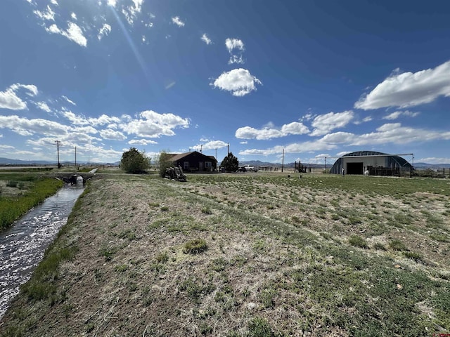 6477 W County Road 9n, Del Norte, CO 81132 - view of yard featuring an outbuilding and a view of countryside