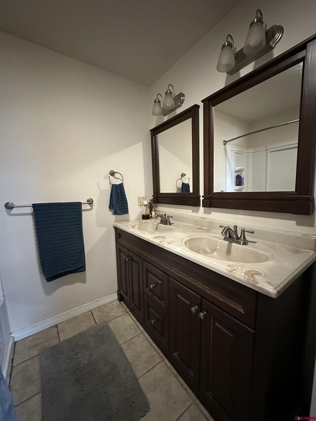 6477 W County Road 9n, Del Norte, CO 81132 - full bathroom with double vanity, tile patterned flooring, and baseboards