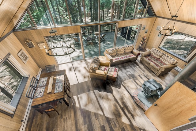 343 Deer Trail Ln, Bayfield, CO 81122 - living room featuring wooden walls, wood finished floors, a chandelier, and a high ceiling