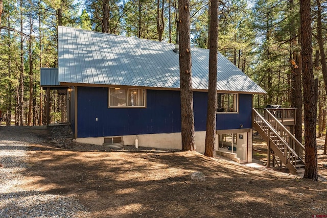 343 Deer Trail Ln, Bayfield, CO 81122 - view of side of home featuring stairway, metal roof, and a wooden deck