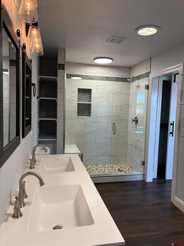 541 Perry Dr, Pagosa Springs, CO 81147 - bathroom featuring a stall shower, wood finished floors, and double vanity