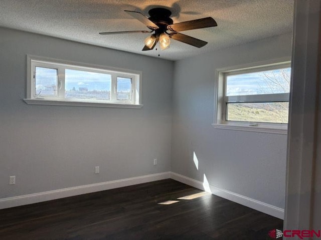 541 Perry Dr, Pagosa Springs, CO 81147 - empty room with a ceiling fan, a textured ceiling, dark wood-type flooring, and baseboards