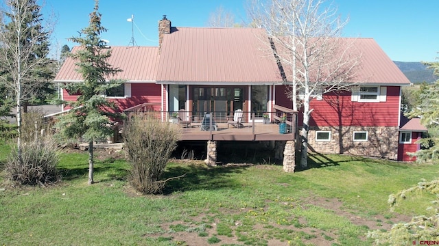 541 Perry Dr, Pagosa Springs, CO 81147 - rear view of property with a wooden deck, a lawn, metal roof, and a chimney