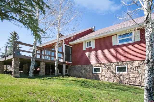 541 Perry Dr, Pagosa Springs, CO 81147 - back of house featuring metal roof, a yard, a wooden deck, and stone siding