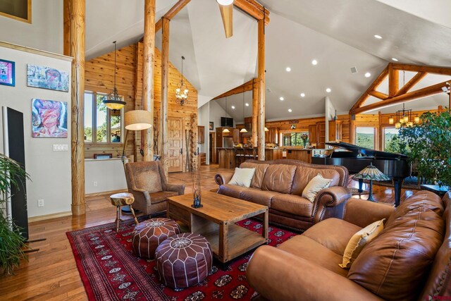 50 W Durango Ridge Rd, Durango, CO 81301 - living room featuring high vaulted ceiling, a chandelier, wooden walls, wood finished floors, and beam ceiling
