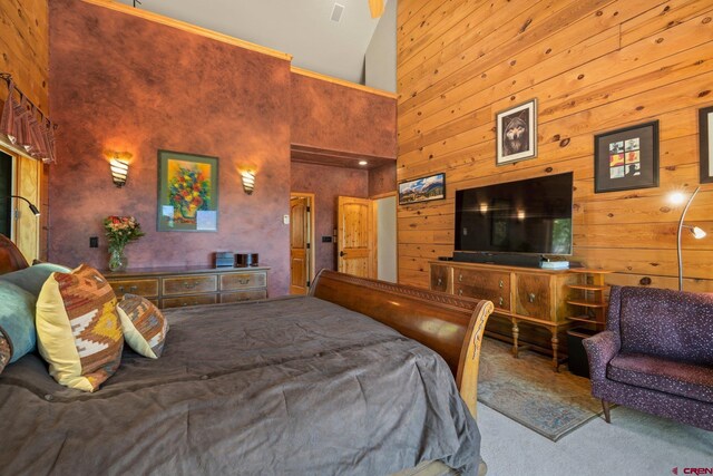50 W Durango Ridge Rd, Durango, CO 81301 - bedroom featuring high vaulted ceiling, carpet flooring, and wood walls
