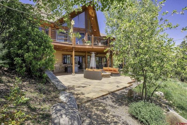 50 W Durango Ridge Rd, Durango, CO 81301 - rear view of property featuring an outdoor living space, a wooden deck, a patio, and stone siding