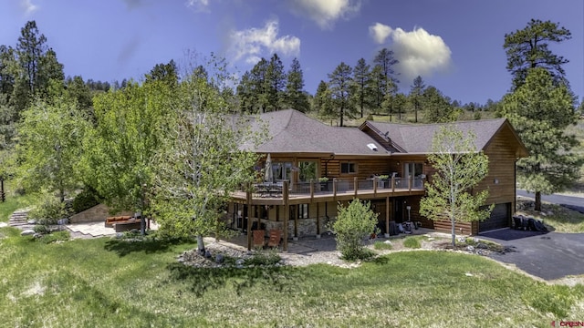 50 W Durango Ridge Rd, Durango, CO 81301 - rear view of property with a wooden deck, a yard, a garage, and asphalt driveway