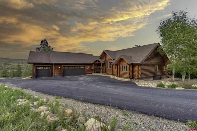 50 W Durango Ridge Rd, Durango, CO 81301 - log cabin featuring log exterior, an attached garage, and driveway