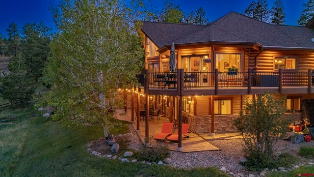 50 W Durango Ridge Rd, Durango, CO 81301 - rear view of house with a patio, stone siding, a shingled roof, and a wooden deck