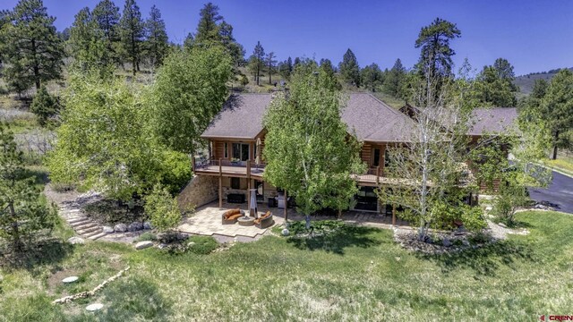 50 W Durango Ridge Rd, Durango, CO 81301 - rear view of property with log siding, a patio area, a yard, and a deck