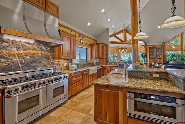 50 W Durango Ridge Rd, Durango, CO 81301 - kitchen featuring stainless steel appliances, under cabinet range hood, brown cabinets, a sink, and lofted ceiling