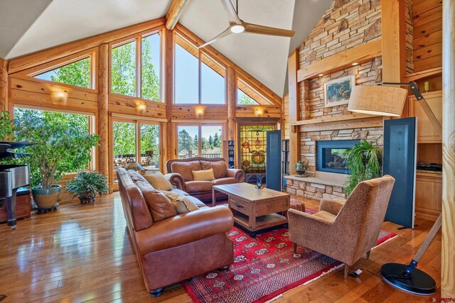 50 W Durango Ridge Rd, Durango, CO 81301 - living area with healthy amount of natural light, light wood-style flooring, a fireplace, high vaulted ceiling, and beam ceiling