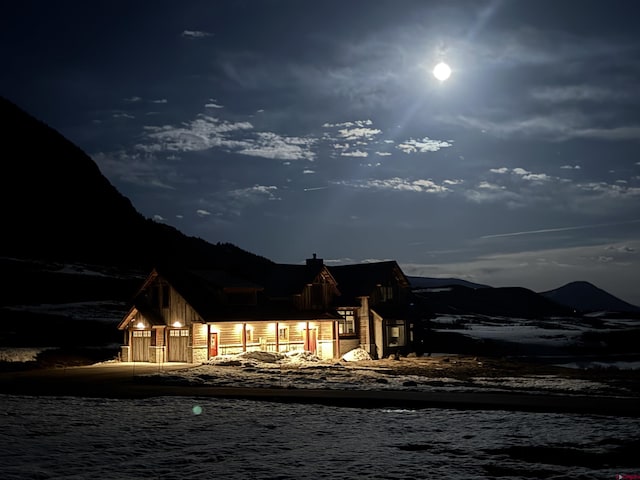 6 Moon Ridge Ln, Crested Butte, CO 81224 - snow covered back of property featuring a mountain view