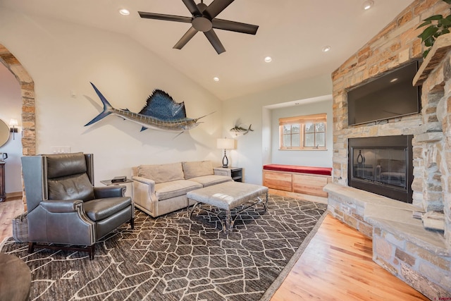 182 Juniper Rd S, Ridgway, CO 81432 - living area featuring lofted ceiling, ceiling fan, wood finished floors, arched walkways, and a stone fireplace