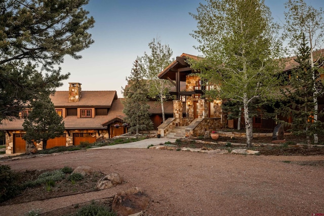 182 Juniper Rd S, Ridgway, CO 81432 - view of front of property with a chimney, a tiled roof, dirt driveway, and stairs