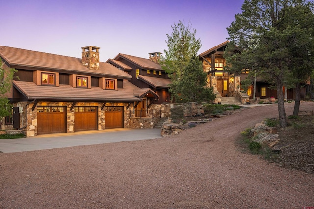 182 Juniper Rd S, Ridgway, CO 81432 - view of front of property featuring driveway, a garage, stone siding, and a tiled roof