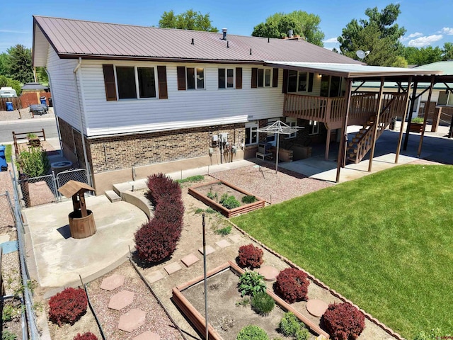 2020 Essex St, Montrose, CO 81401 - rear view of property with a vegetable garden, a patio, brick siding, a gate, and metal roof