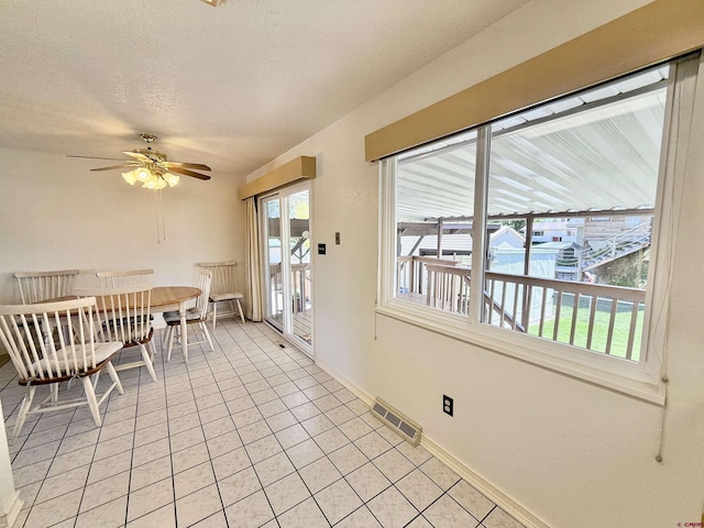 2020 Essex St, Montrose, CO 81401 - dining room featuring light tile patterned floors, a ceiling fan, baseboards, and a textured ceiling