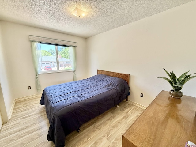 2020 Essex St, Montrose, CO 81401 - bedroom with light wood-style flooring and a textured ceiling