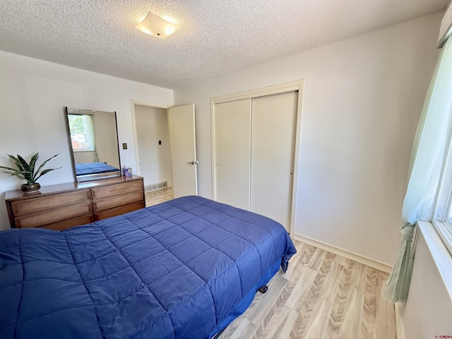 2020 Essex St, Montrose, CO 81401 - bedroom with light wood finished floors, a textured ceiling, and a closet