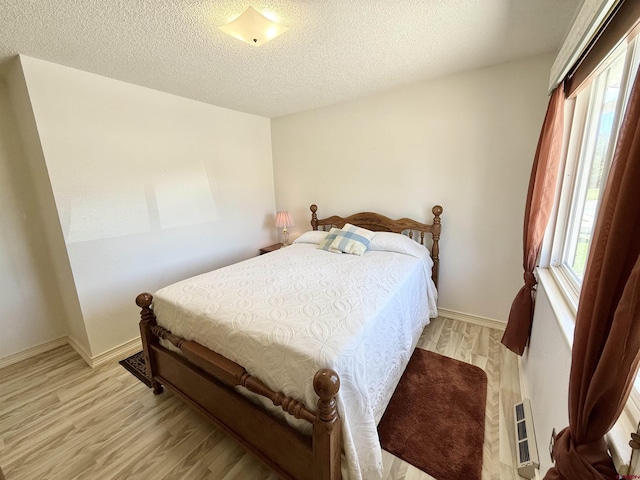2020 Essex St, Montrose, CO 81401 - bedroom with light wood-style floors, a textured ceiling, and baseboards