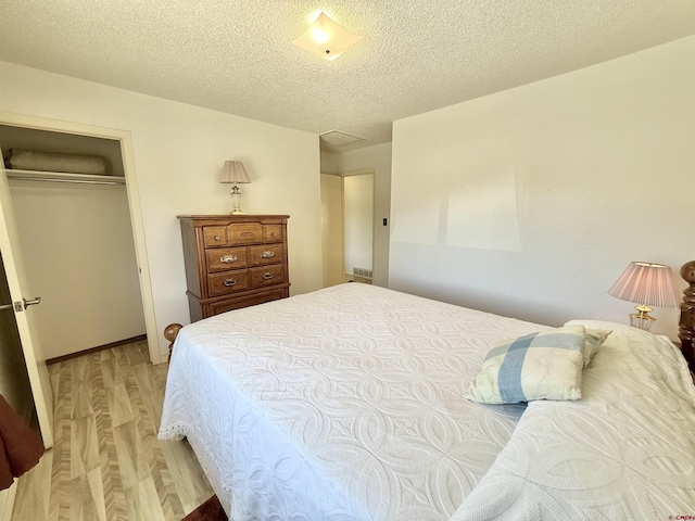 2020 Essex St, Montrose, CO 81401 - bedroom with light wood finished floors, a textured ceiling, and a closet