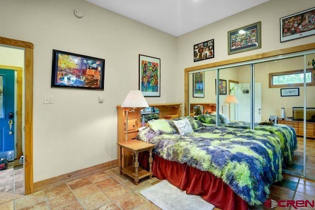 538 Rugby Mines Rd, Walsenburg, CO 81089 - bedroom featuring baseboards, stone tile floors, and a closet