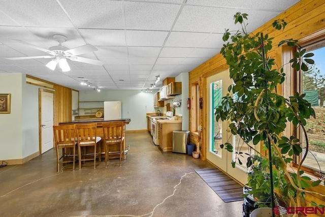 538 Rugby Mines Rd, Walsenburg, CO 81089 - dining area featuring finished concrete floors, baseboards, and a drop ceiling