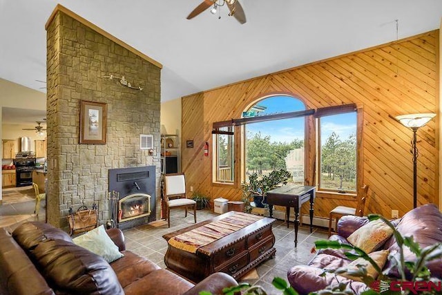 538 Rugby Mines Rd, Walsenburg, CO 81089 - tiled living room featuring ceiling fan, vaulted ceiling, and wooden walls