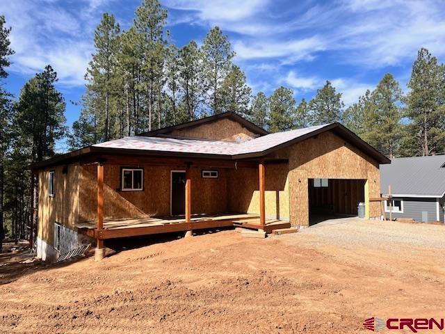 86 Spruce Way, Bayfield, CO 81122 - view of front of house with a garage, driveway, and a deck