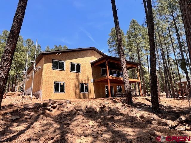 86 Spruce Way, Bayfield, CO 81122 - rear view of house featuring a balcony and stucco siding