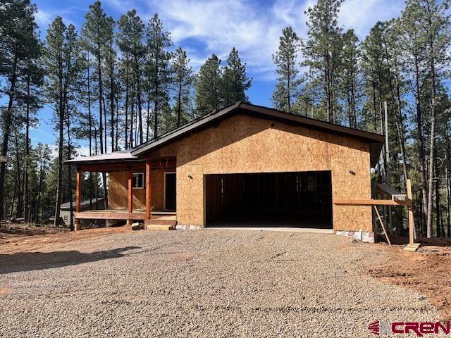 86 Spruce Way, Bayfield, CO 81122 - view of front of house with driveway, an attached garage, and covered porch