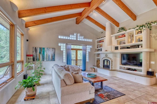 520B Whispering Wood Dr, Pagosa Springs, CO 81147 - living room with beamed ceiling, stone tile floors, a glass covered fireplace, and high vaulted ceiling