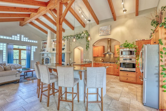 520B Whispering Wood Dr, Pagosa Springs, CO 81147 - kitchen with appliances with stainless steel finishes, high vaulted ceiling, beamed ceiling, stone tile flooring, and open floor plan
