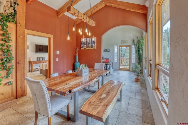 520B Whispering Wood Dr, Pagosa Springs, CO 81147 - dining room featuring arched walkways, beamed ceiling, high vaulted ceiling, stone tile floors, and baseboards