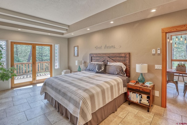 520B Whispering Wood Dr, Pagosa Springs, CO 81147 - bedroom featuring stone tile floors, a textured wall, access to outside, multiple windows, and recessed lighting