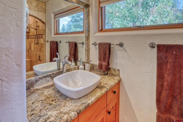 520B Whispering Wood Dr, Pagosa Springs, CO 81147 - bathroom with a tile shower, vanity, and a textured wall