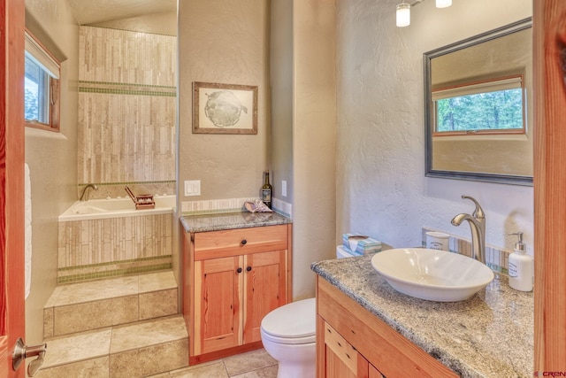 520B Whispering Wood Dr, Pagosa Springs, CO 81147 - full bath with a textured wall, a bath, vanity, toilet, and plenty of natural light