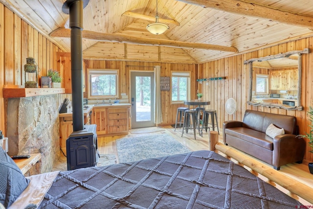520B Whispering Wood Dr, Pagosa Springs, CO 81147 - bedroom with a wood stove, wood ceiling, vaulted ceiling, wooden walls, and light wood-style floors