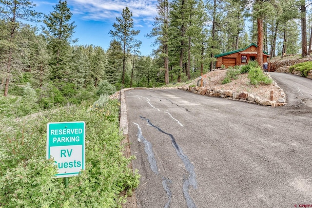 520B Whispering Wood Dr, Pagosa Springs, CO 81147 - view of asphalt driveway featuring a forest view