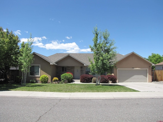 1756 Freedom Way, Montrose, CO 81401 - ranch-style house with a garage, concrete driveway, and stucco siding